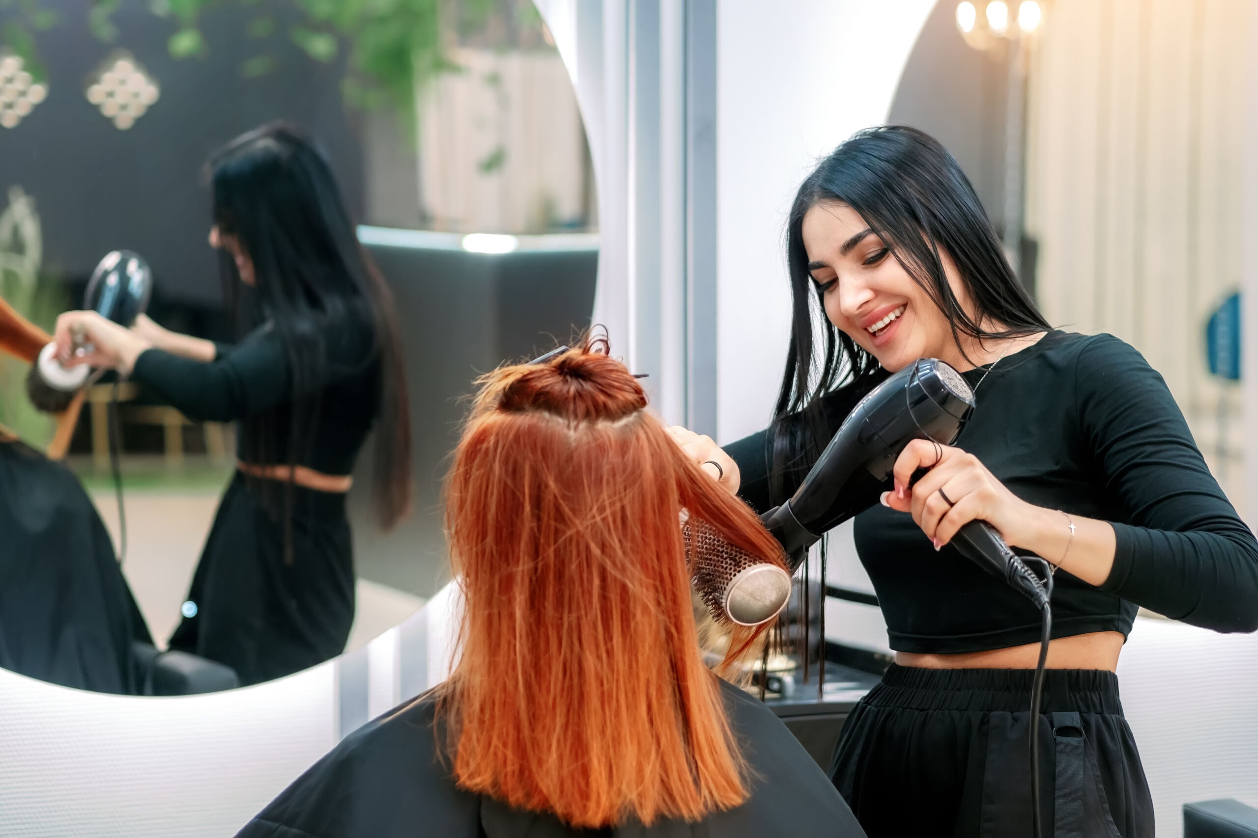 Woman getting her hair blow-dried in a salon